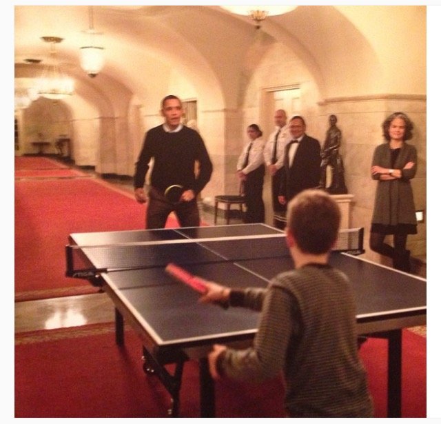 Obama playing ping pong with boy